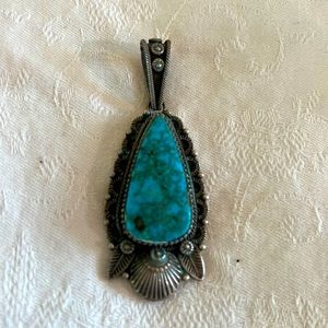 Turquoise and sterling silver pendant crafted by a Native American artist.